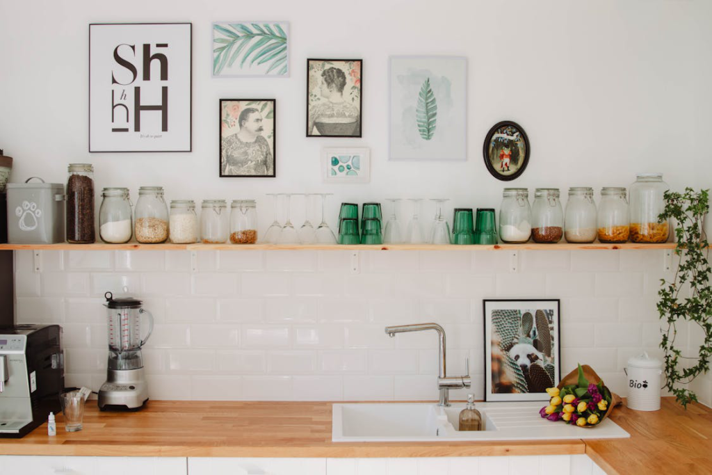 A kitchen wall shelf lined with containers