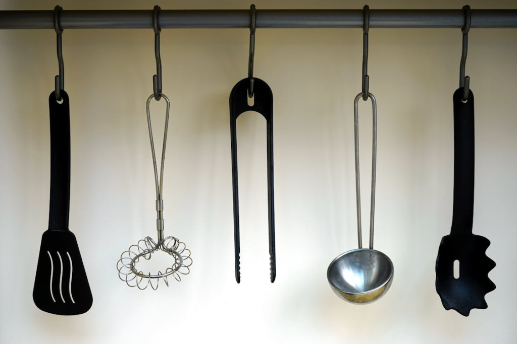 Cooking and baking utensils hanging in a kitchen