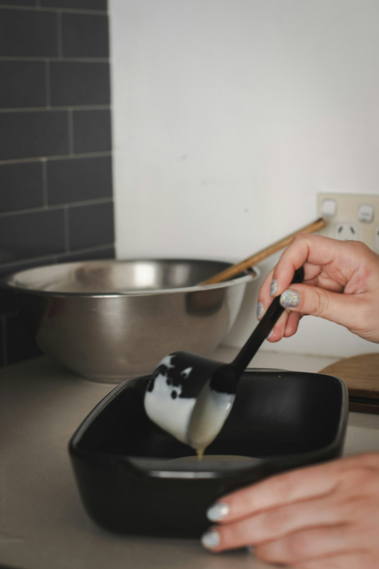 A person using a silicone spatula